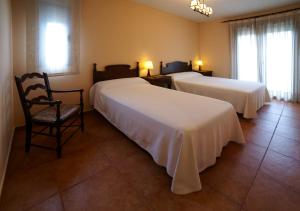 拉耶斯萨尔瓦多特哈尔乡村旅馆的酒店客房,配有两张床和椅子