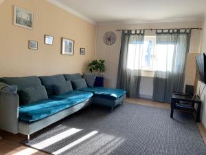 科隆Ferienwohnung mit Garten in Köln的客厅配有蓝色的沙发和电视