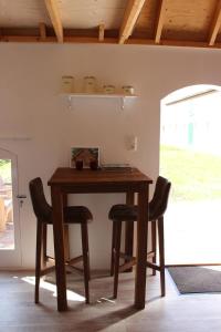 阿赫特克克Trekkershuisje 't Zeeuws Knoopje的一张木桌,房间内设有两把椅子