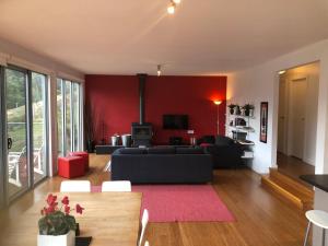 默立基Stirling View的客厅配有黑色沙发和红色墙壁