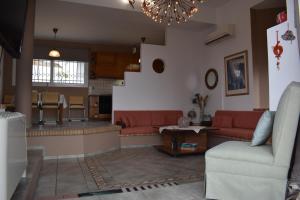 AiándionProsili的一间带红色沙发的客厅和一间厨房