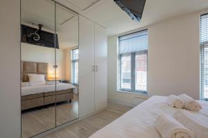 阿尔克马尔Luxury City Home Alkmaar nearby Amsterdam.的一间卧室配有两张床和镜子