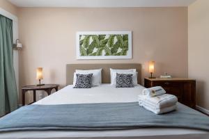 里约热内卢Sofisticado em Copacabana - 2 Suites - A801的一间卧室配有一张带两盏灯的大型白色床。
