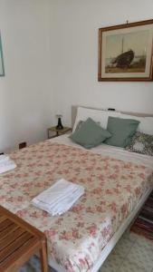 罗马Apartment Metro Tor Di Valle的卧室配有一张带桌子的床,墙上挂着一张照片