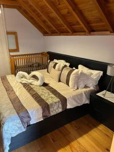 莫尼兹港Waves Song - Cottage的一间卧室配有带枕头的床
