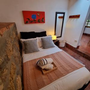 莱瓦镇Casita Artemisa - Tiny House Romántica y Mágica的一间卧室配有一张大床、毯子和枕头