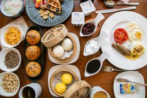 顺义北京临空皇冠假日酒店的木桌,上面放有盘子和碗的食物