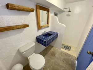 图卢姆MIO Tulum Hotel Boutique的浴室设有卫生间和蓝色瓷砖水槽。