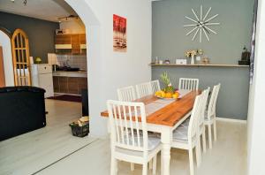 亚伊采Lola's House的厨房以及带木桌和椅子的用餐室。