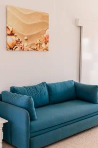 普罗塔拉斯弗罗卡斯公寓酒店的墙上画画的蓝色沙发