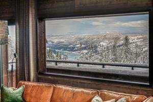 奥耶New ap The Nest in Hafjell ski in out and fast Wifi的从窗户可欣赏到白雪 ⁇ 的山景