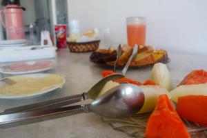 康塞桑达巴拉太阳花旅馆的一张桌子,上面有汤匙和一些水果