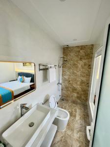 Kinh DinhKHÁCH SẠN Biển Xanh的一间带水槽和卫生间的浴室以及一张床