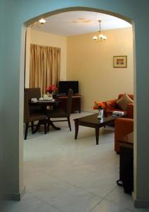 阿吉曼New Royal Palace Hotel Apartments的客厅配有桌子和沙发