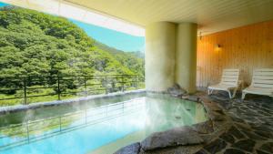 会津若松Ooedo Onsen Monogatari Higashiyama Grand Hotel的山景别墅内的游泳池
