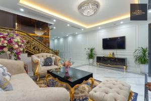 下龙湾Luxury Homestay Vinhomes Dragonbay Hạ Long的客厅配有家具和电视。