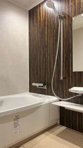 萩市萩之宿巴旅馆的带淋浴和浴缸的浴室
