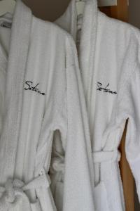 巴古尔Hotel Sa Tuna的两条白色毛巾,上面写着黑色的文字