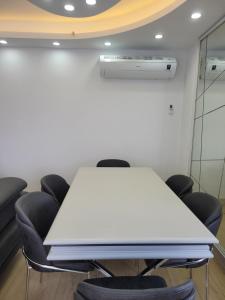 伯萨Bursa Dream Apartment的一间会议室,配有白色的桌子和椅子