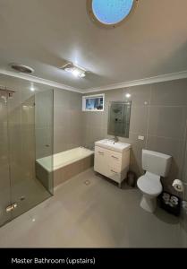 麦夸里港5 OClock Somewhere 6BR sleeps 18 with Kids Retreat的浴室配有卫生间、淋浴和盥洗盆。