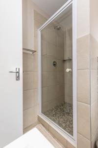德班67 The Shades - Luxury Apartment in Umhlanga - Airconditioning throughout and Inverter的浴室里设有玻璃门淋浴