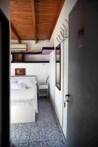 布宜诺斯艾利斯巴勒莫苏荷旅馆的卧室设有白色的床和木制天花板。