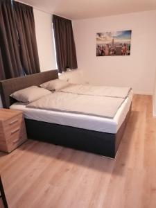 丁克拉格Altes Gesellenhaus的卧室内的一张大床,铺有木地板