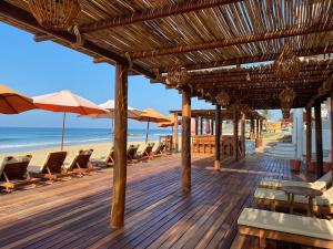 兹波利特Hotel Estrella de Mar的海滩上带椅子和遮阳伞的甲板