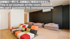 郡山Tabist Onsen Petit Hotel Yukori Bandai Atami的带沙发和枕头的客房