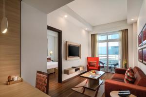 诺伊达Sandal Suites by Lemon Tree Hotels的客厅配有沙发和椅子