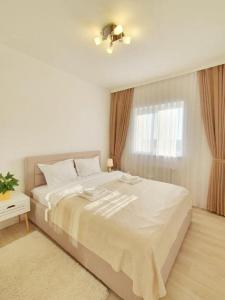 奥拉迪亚2 Bedrooms - Skyblue Central apartment的白色的卧室设有一张大床和一个窗户