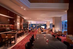 棉兰棉兰JW万豪酒店的一间带桌椅的餐厅和一间酒吧
