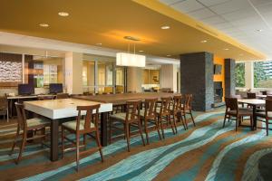 卡尔加里Fairfield Inn & Suites by Marriott Calgary Downtown的大型用餐室配有桌椅