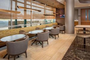 弗雷德里克SpringHill Suites By Marriott Frederick的用餐室设有桌椅和窗户。