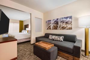 卡梅尔印第安纳波利斯卡梅尔春季山丘套房酒店的客厅配有沙发和1张床