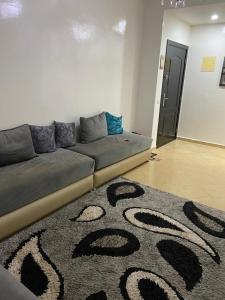 DerouaCasablanca Airport Appartement的客厅的沙发,铺有地毯