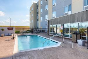 欧文斯伯勒TownePlace Suites by Marriott Owensboro的大楼前的游泳池
