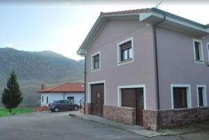 CanalesCasa Balbi的前面有一辆汽车停放的白色房子