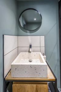 ShouldhamPark Lane Studio, Shouldham的一间带水槽和圆镜子的浴室