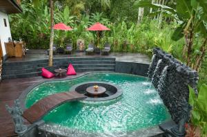 乌布Masakali Retreat的花园中央带喷泉的游泳池