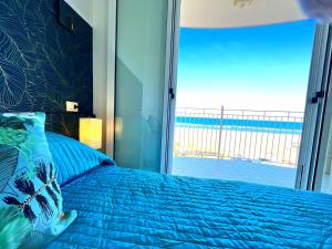 里米尼Residence Frontemare的一间卧室设有蓝色的床和大窗户