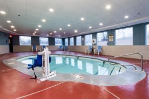 Swansea斯温西智选假日套房酒店的游泳池,带桌椅的房间