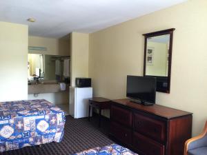奥古斯塔Knights Inn Augusta Fort Gordon的酒店客房设有一间带一张床和电视的卧室