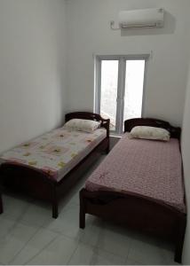 BonorejoRumah Bahagia 36的两张床位于带窗户的房间内