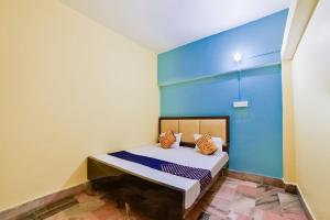 BankipurSPOT ON Luv-kush Inn的一间卧室配有一张蓝色墙壁的床