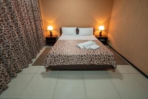 塔什干Rohat Hotel Chilonzor的一间卧室配有一张床,上面有两条毛巾