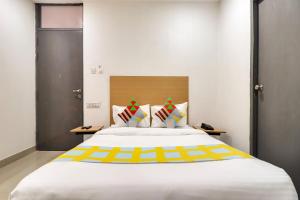 HasanganjOYO Home Basera Homes的卧室配有一张白色大床,拥有黄色色调
