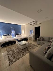 开罗Lucky Hostel的一间带两张床和一张沙发的客厅