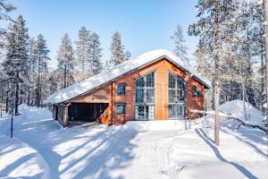 列维Villa Amiraali Levi的雪中树下的小木屋