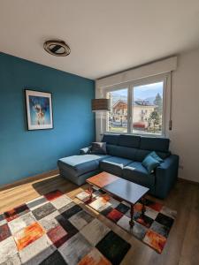 圣文森特Maison Alice的客厅配有蓝色的沙发和桌子